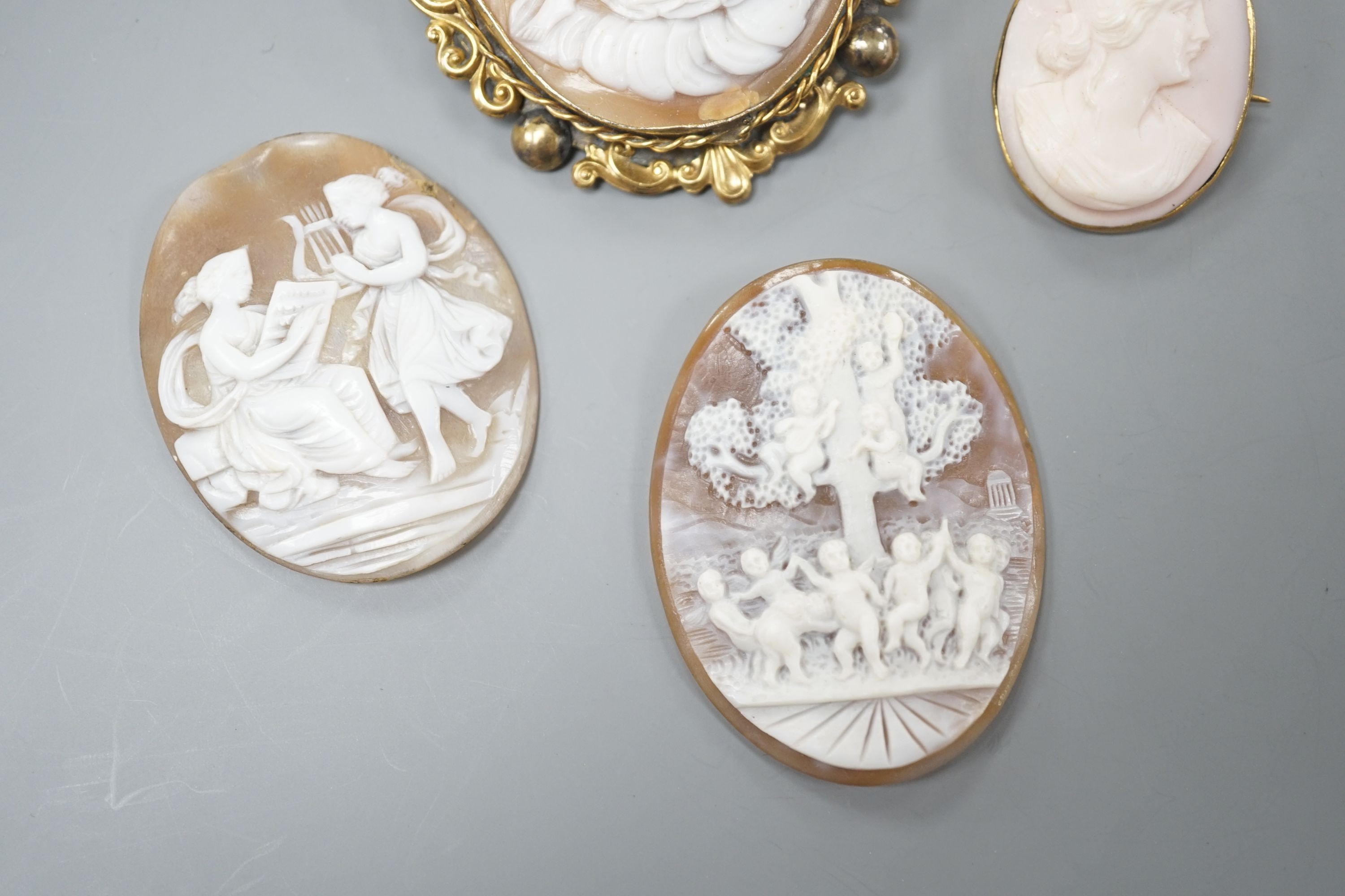 Two gilt metal mounted carved oval cameo shell cameos, largest 63mm and two similar unmounted cameos.